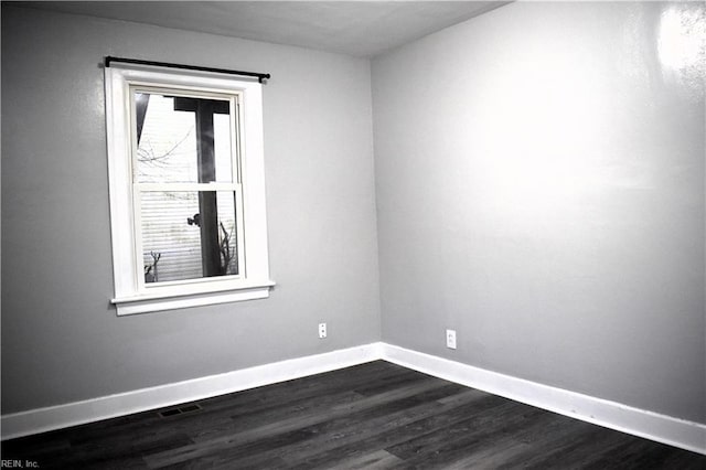 unfurnished room featuring dark hardwood / wood-style floors