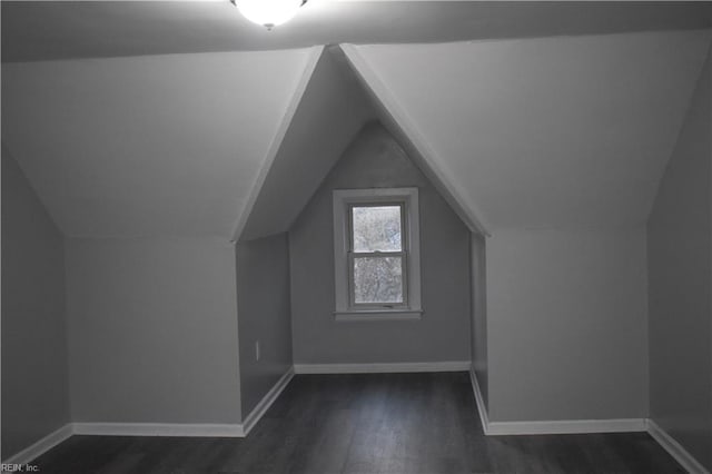 bonus room featuring vaulted ceiling and dark hardwood / wood-style floors