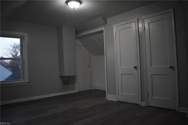 additional living space with dark hardwood / wood-style floors