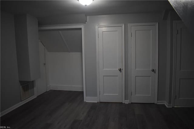 additional living space featuring dark hardwood / wood-style floors