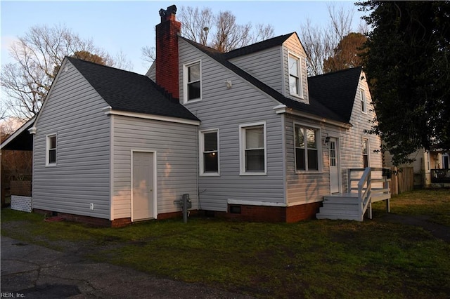 rear view of house featuring a yard