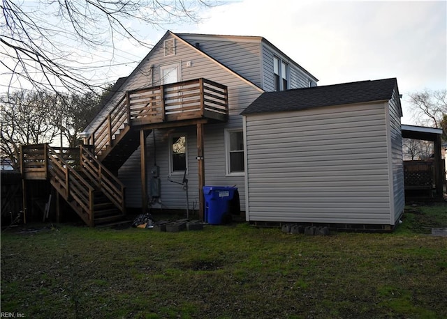 rear view of house featuring a yard