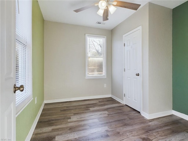 unfurnished bedroom featuring dark wood-type flooring and ceiling fan