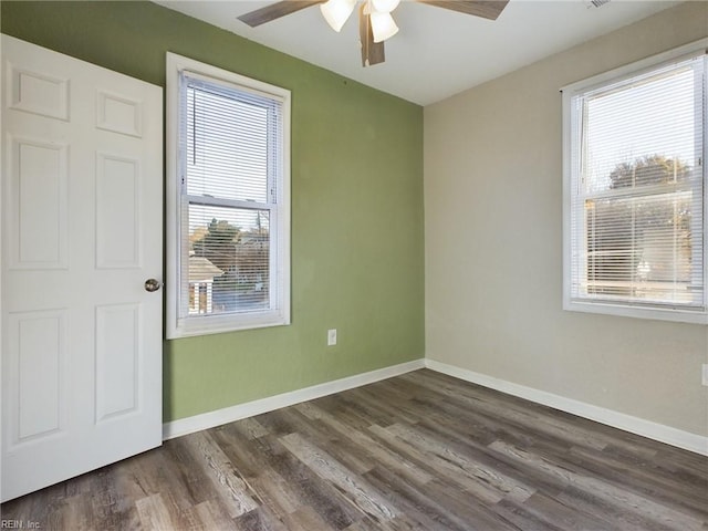 unfurnished room featuring dark wood-type flooring and ceiling fan