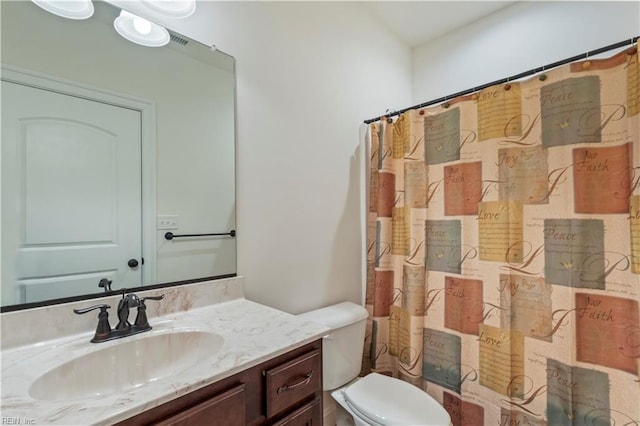 bathroom featuring vanity, toilet, and curtained shower