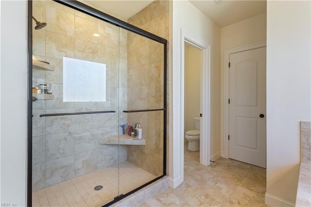 bathroom with toilet and an enclosed shower