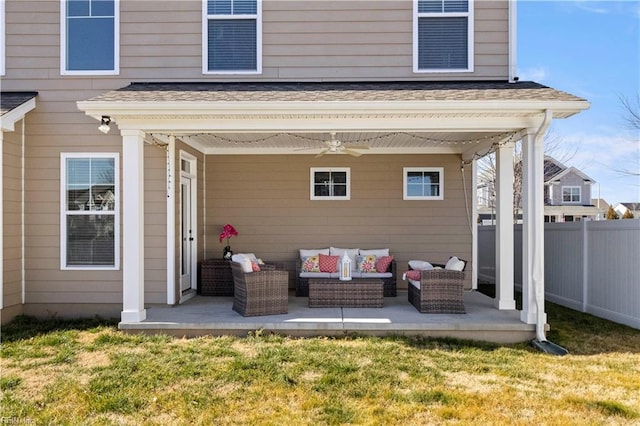 rear view of property with an outdoor living space, a yard, and ceiling fan