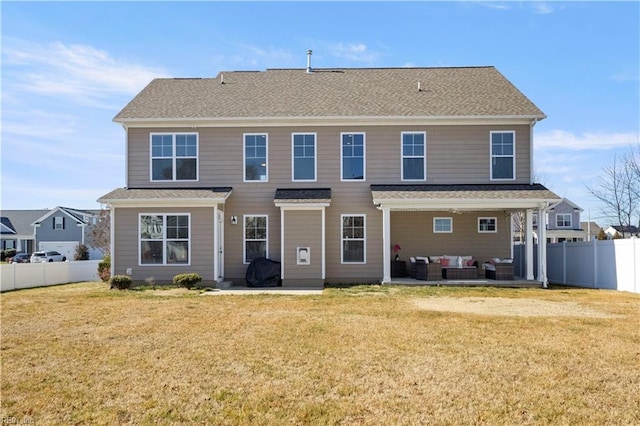 rear view of property with a patio area, outdoor lounge area, and a lawn