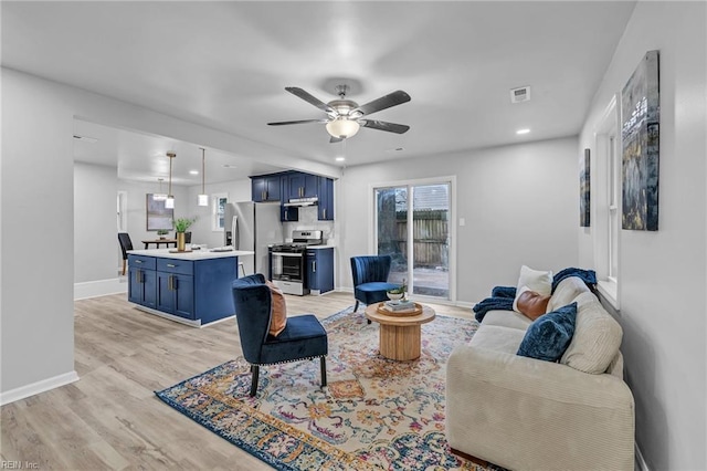 living room with ceiling fan and light hardwood / wood-style floors