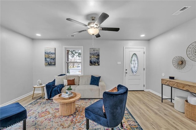 living room featuring ceiling fan and light wood-type flooring