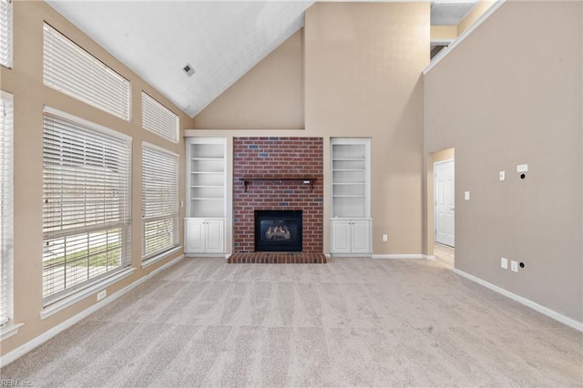 unfurnished living room featuring high vaulted ceiling, light colored carpet, built in features, and a fireplace