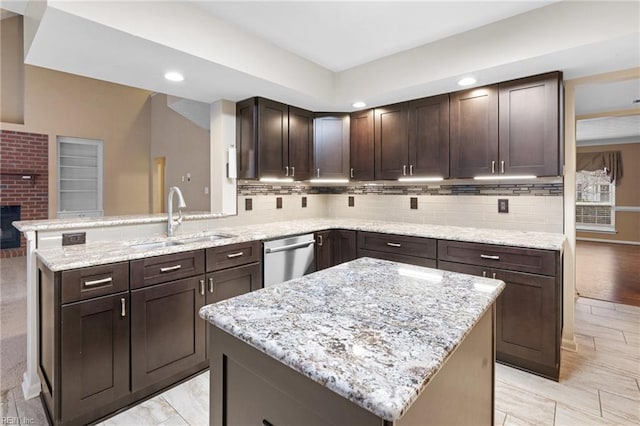 kitchen featuring sink, dishwasher, dark brown cabinets, light stone counters, and kitchen peninsula