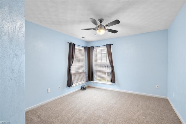 carpeted empty room featuring ceiling fan