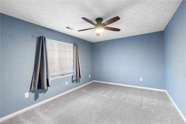 carpeted spare room featuring ceiling fan