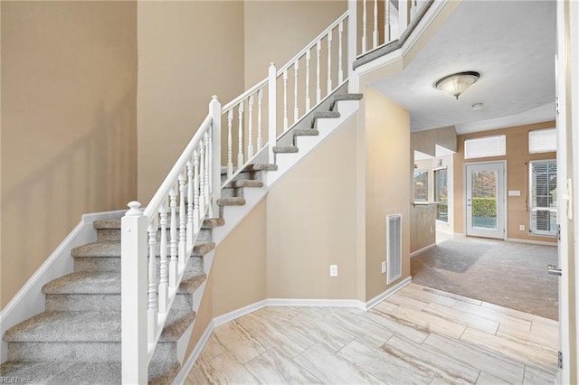 staircase with a towering ceiling