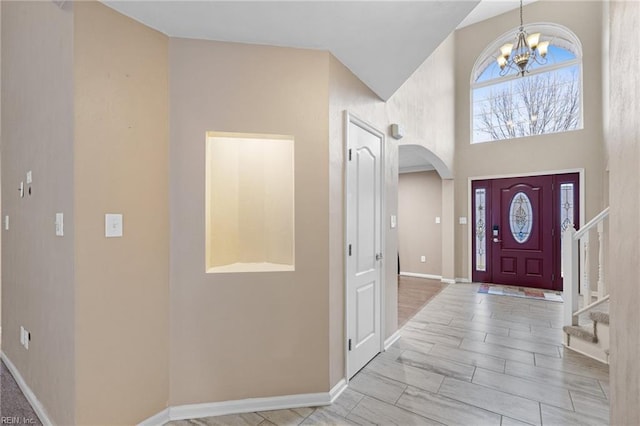 foyer featuring a high ceiling and a notable chandelier