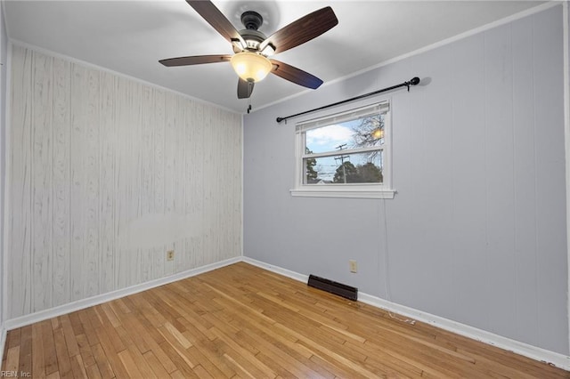 unfurnished room with crown molding and light hardwood / wood-style floors