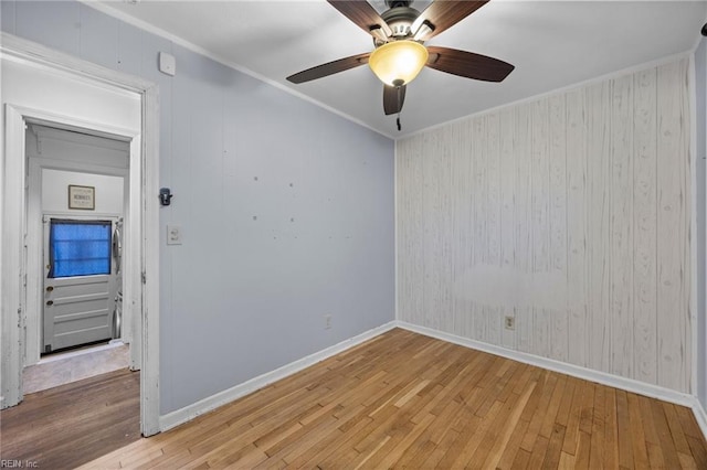 spare room featuring hardwood / wood-style flooring, ornamental molding, and ceiling fan