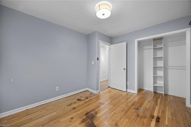 unfurnished bedroom featuring a closet and light hardwood / wood-style flooring