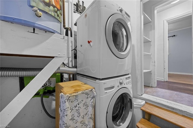 washroom featuring stacked washer and clothes dryer and hardwood / wood-style floors