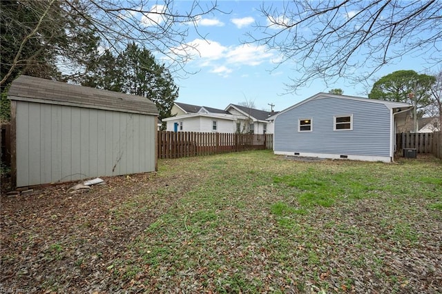 view of yard featuring central AC unit and a storage shed