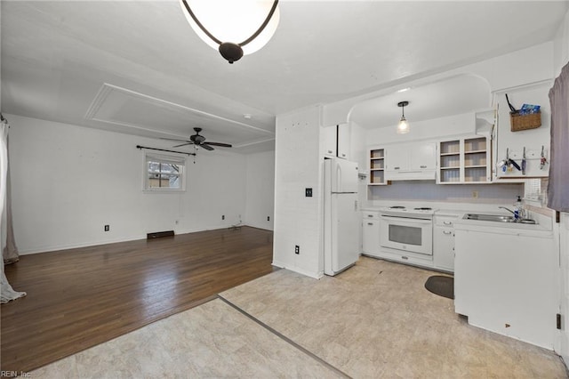 kitchen featuring sink, white cabinetry, decorative light fixtures, light hardwood / wood-style flooring, and white appliances