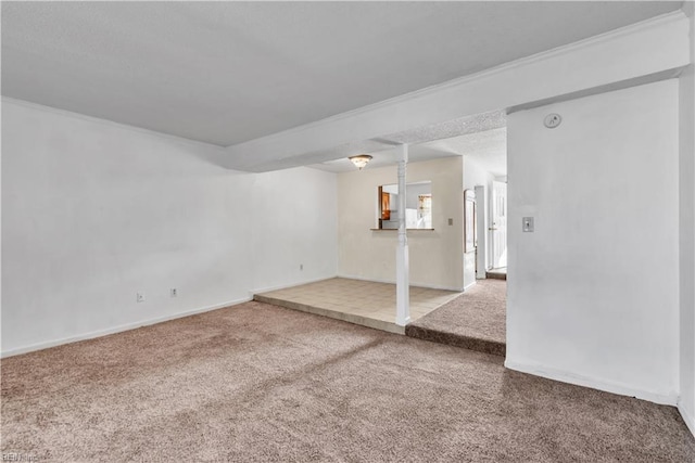 spare room with ornamental molding and carpet