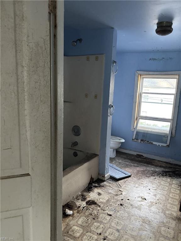 bathroom with shower / tub combination and toilet