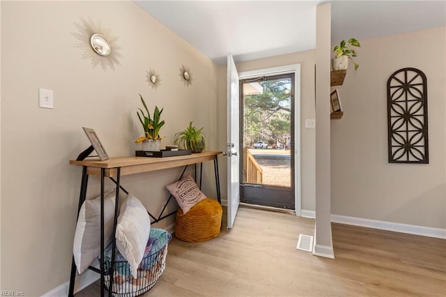 entryway with light hardwood / wood-style floors