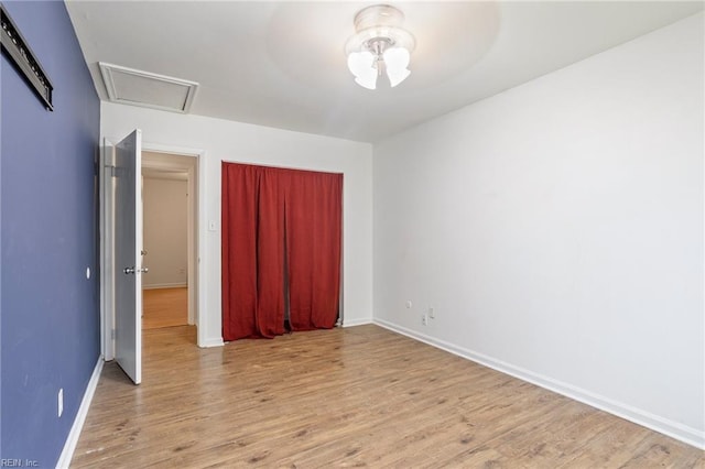 unfurnished bedroom featuring a closet and light wood-type flooring