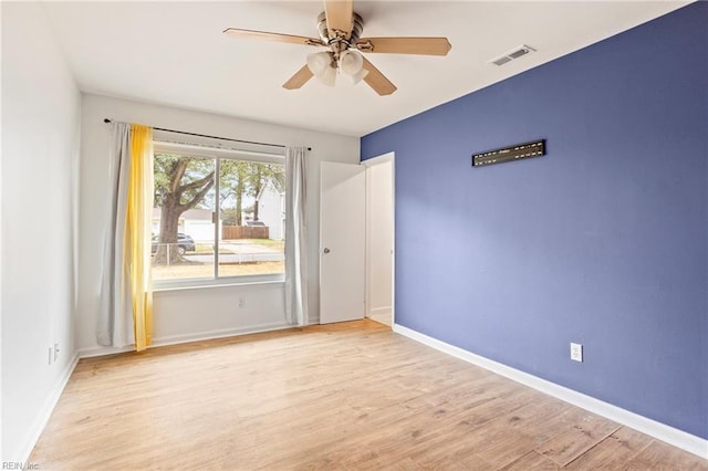 empty room with ceiling fan and light wood-type flooring