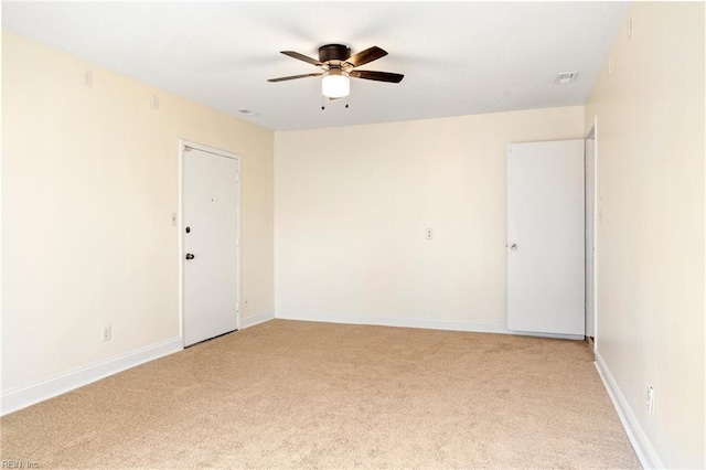 carpeted spare room with ceiling fan