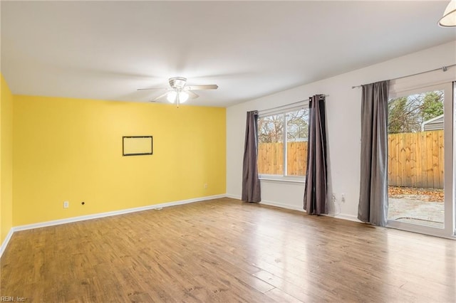 unfurnished room with ceiling fan and wood-type flooring