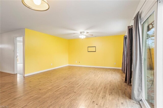 empty room with ceiling fan and light wood-type flooring