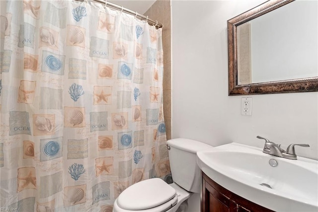 bathroom featuring walk in shower, vanity, and toilet