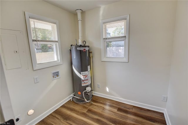 utility room featuring electric panel and gas water heater