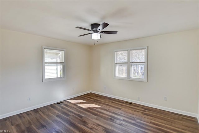 unfurnished room with dark wood-type flooring and ceiling fan