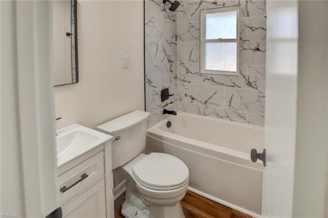 full bathroom with vanity, hardwood / wood-style floors, tiled shower / bath combo, and toilet