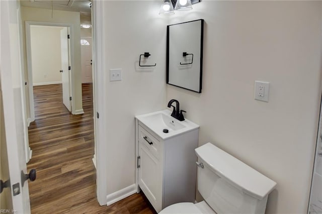 bathroom with vanity, toilet, and wood-type flooring