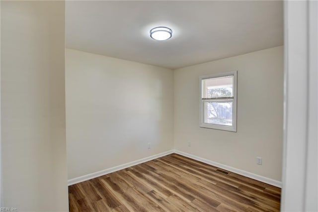 unfurnished room featuring dark wood-type flooring