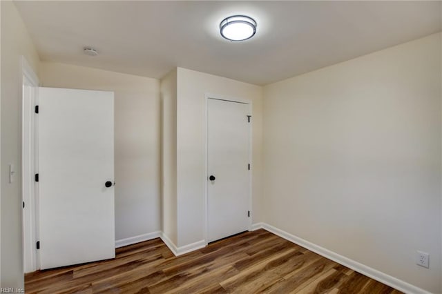 unfurnished bedroom with wood-type flooring and a closet