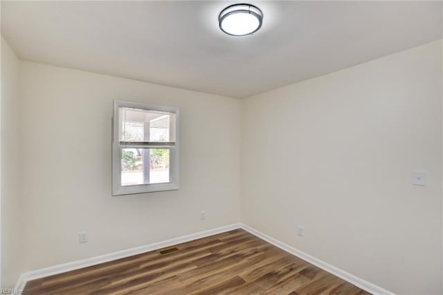 empty room featuring dark hardwood / wood-style floors