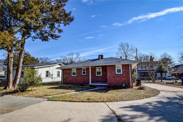 view of front of house with central AC and a front yard