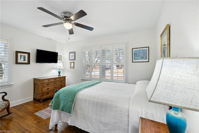 bedroom with dark hardwood / wood-style floors and ceiling fan