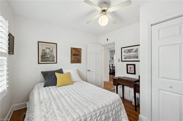 bedroom with dark wood-type flooring and ceiling fan