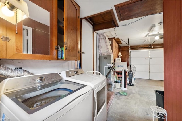 clothes washing area with washer and clothes dryer