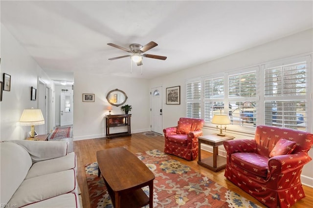 living room featuring ceiling fan and light hardwood / wood-style floors