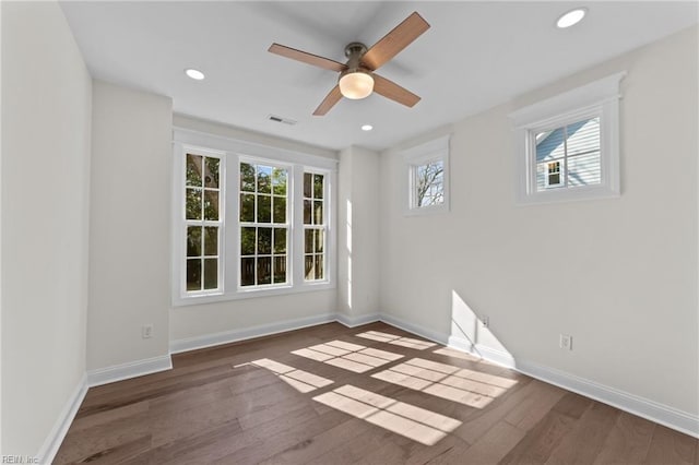 empty room featuring recessed lighting, visible vents, baseboards, and wood finished floors