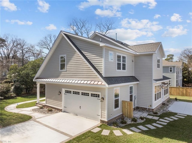 view of front of property featuring a shingled roof, concrete driveway, fence, a garage, and a front lawn