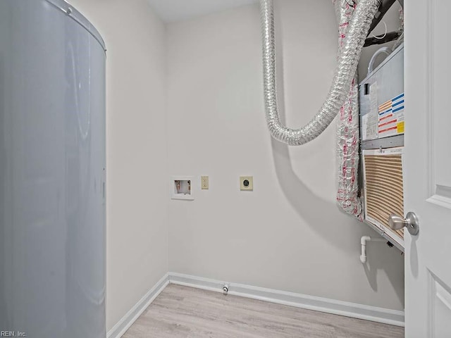 clothes washing area featuring light wood-style floors, baseboards, hookup for an electric dryer, hookup for a washing machine, and laundry area